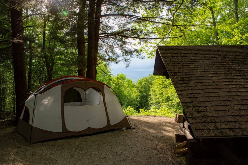 Vermont campsite with tent, shelter and surrounding forest.