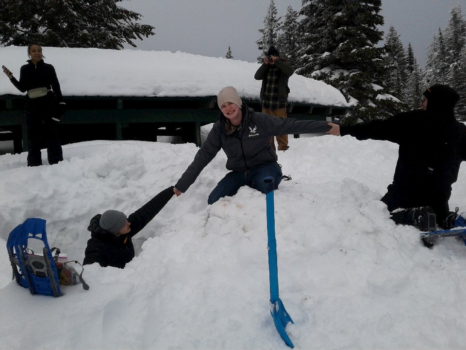 Teens playing in the snow.