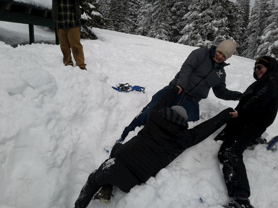 Teens practicing snow safety tactics.