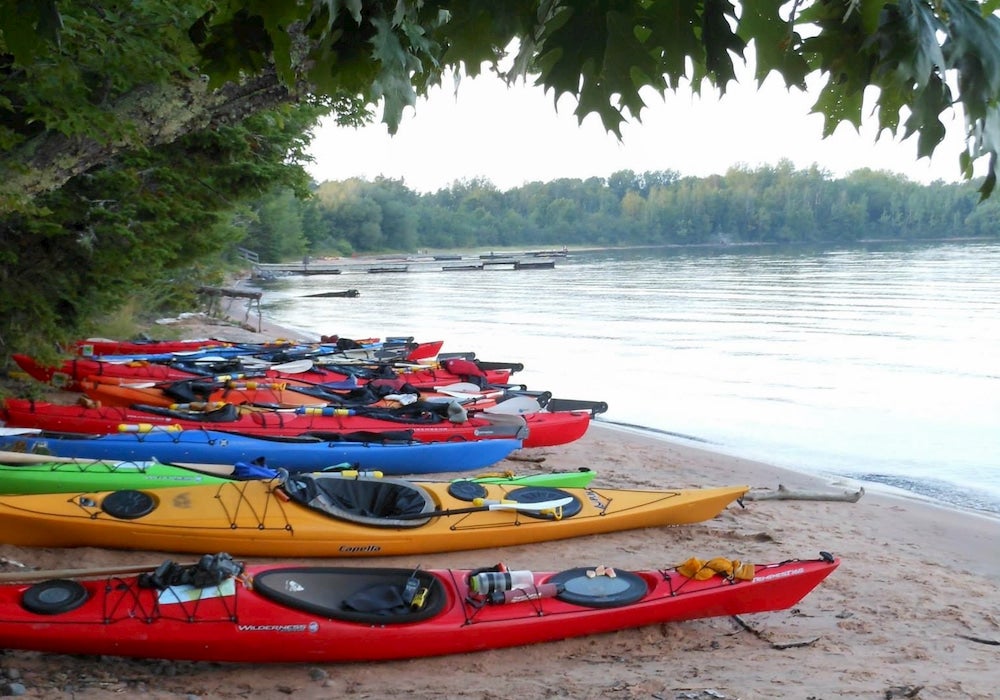 Kayaks on beach along lakeshore