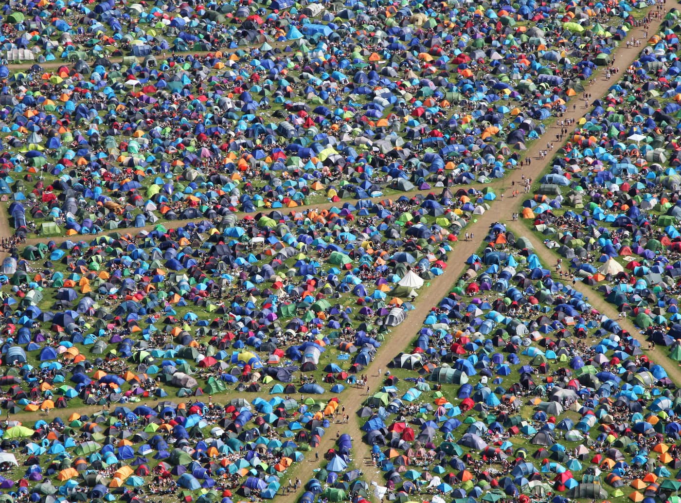 Aerial image of field full of tents camping at a music festival