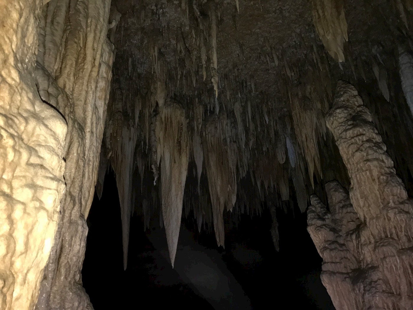 Stalactites in a dark cave.