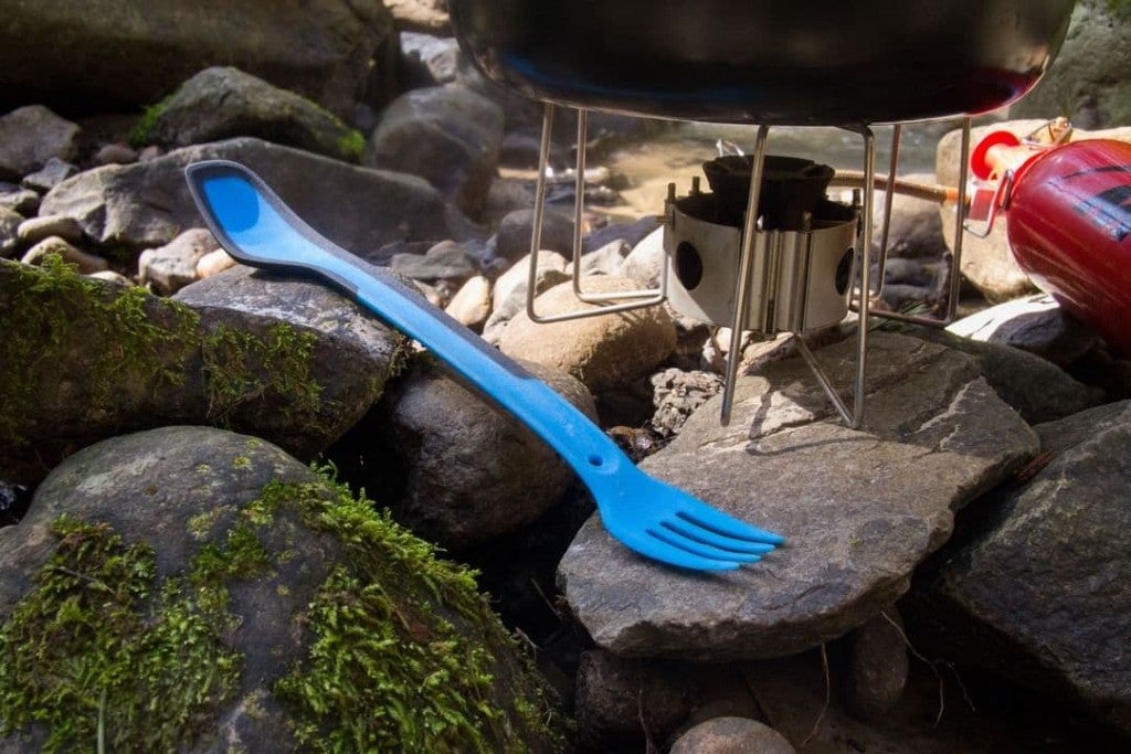 blue morsel spork on rocks next to backpacking stove