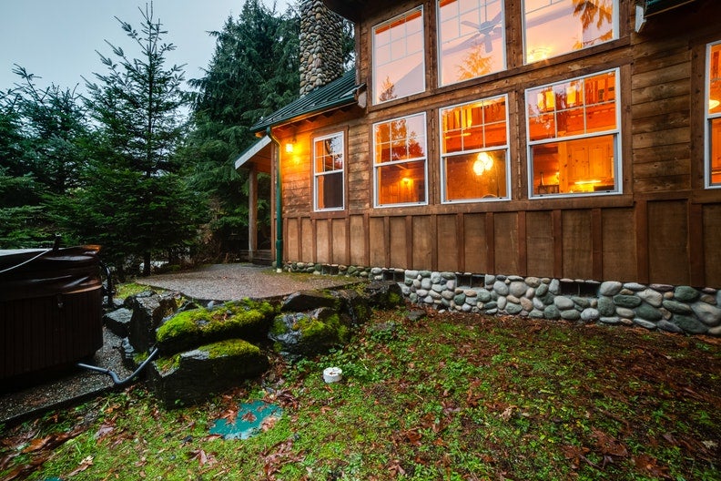 a large family cabin on mount baker with a river rock chimney