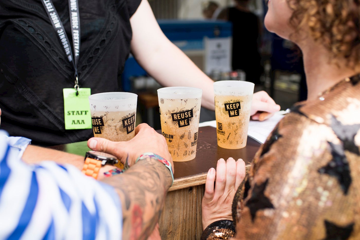 Cups at a ferstival bar with "Reuse Me" labels..