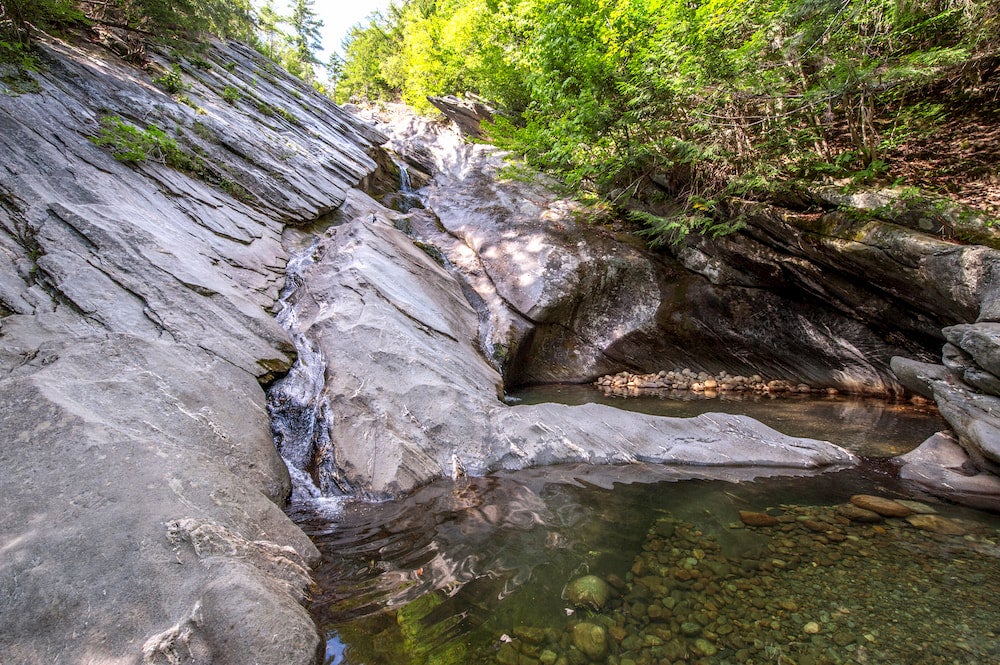 a waterfall flowing sideways down a rock face in vermont