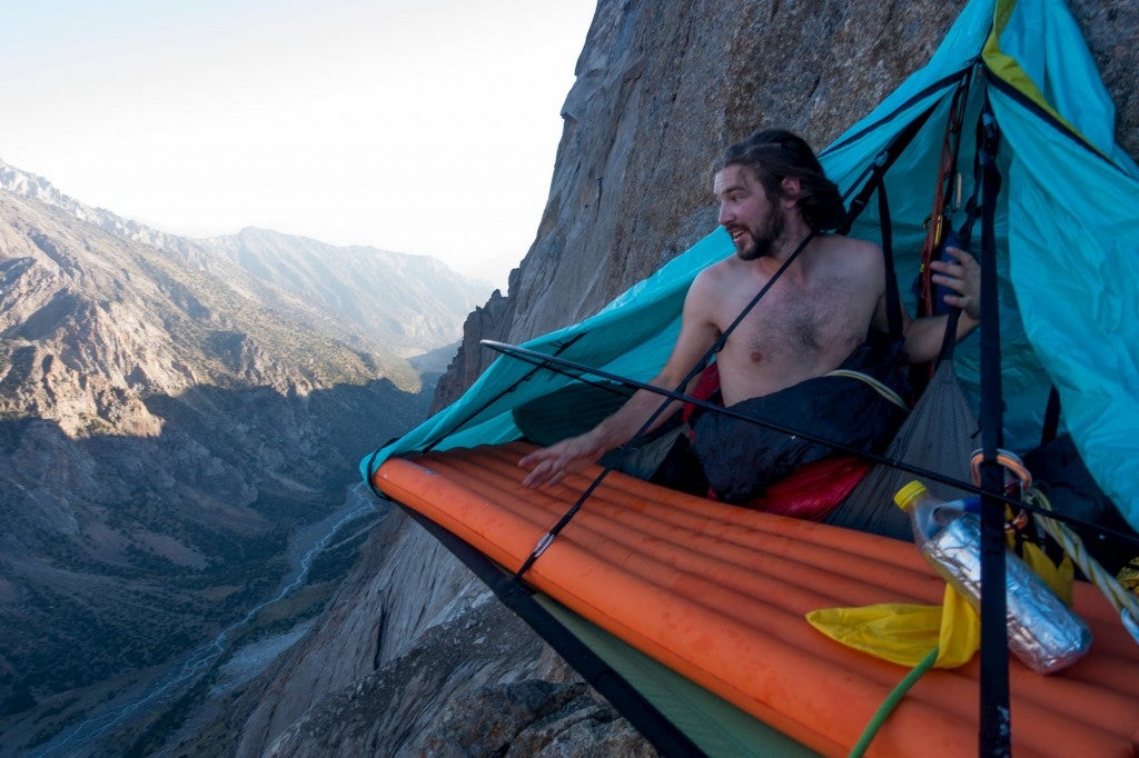 Climber waking up in bivouac on the side of a big wall.
