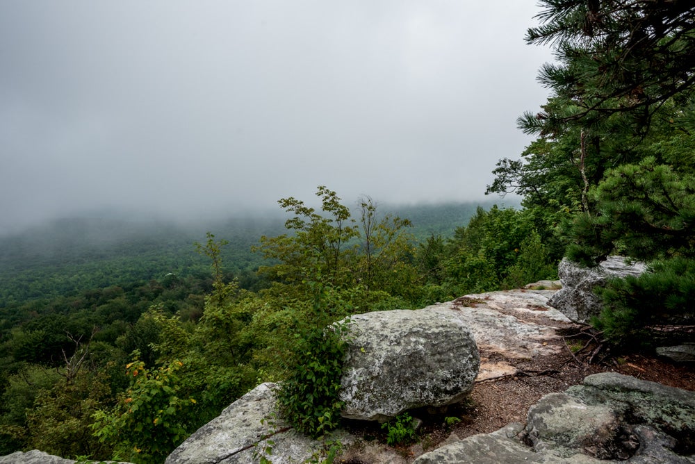 Fog covered viewpoint on a rocky precipice in the Catskills.