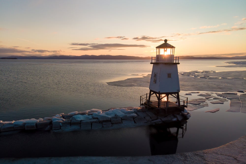 the burlington harbor lighthouse at sunset in vermont