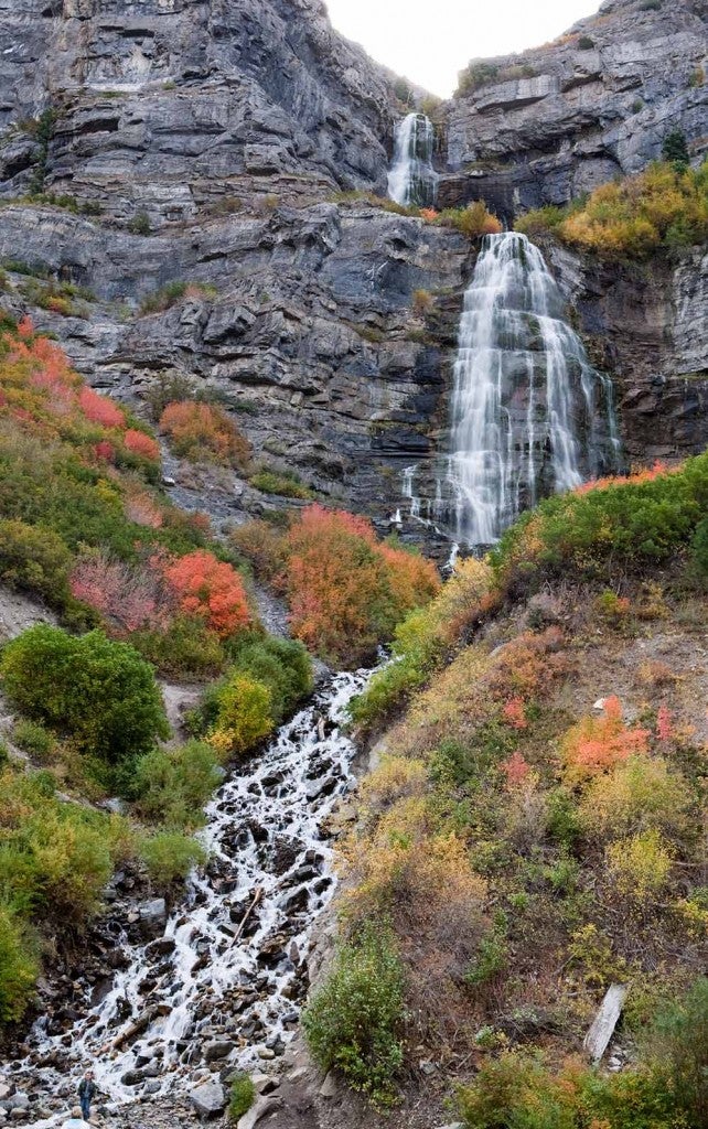 two neighboring waterfalls in utah flowing from a cliff face