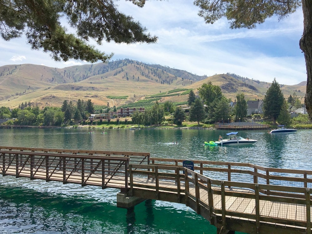River walk along Lake Chelan, WA with boats in the background.
