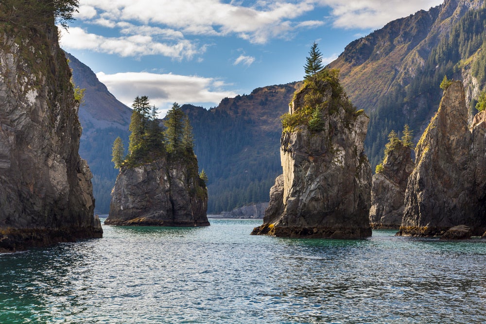 Rock formations jutting out of the water at Kenai Fjords National Park.