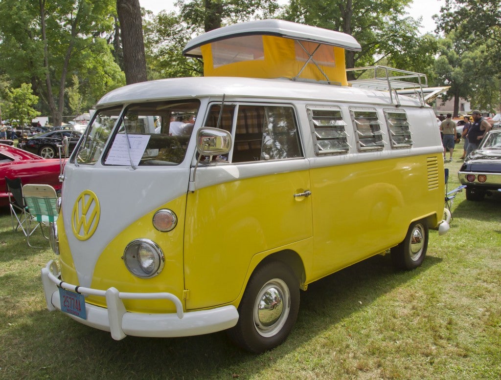 a volkswagon pop-up camper painted bright yellow
