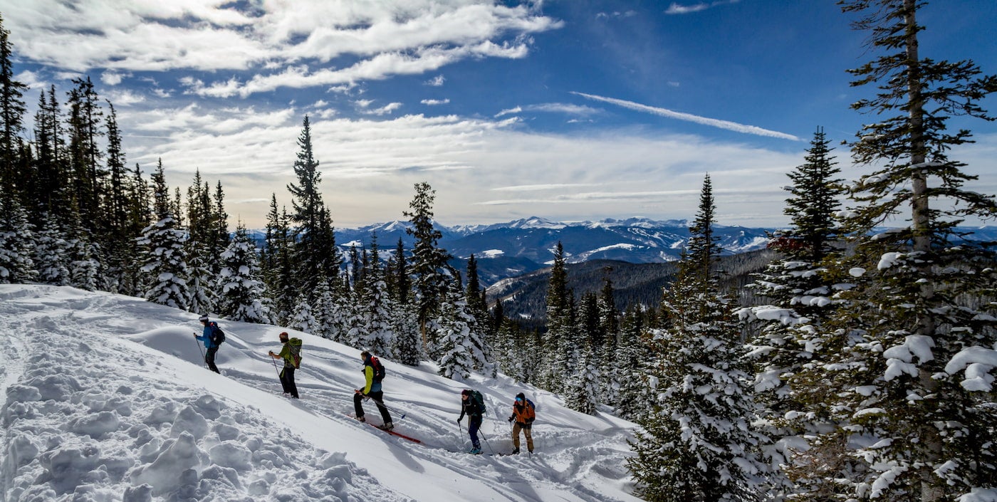 Backcountry skiers hiking uphill.