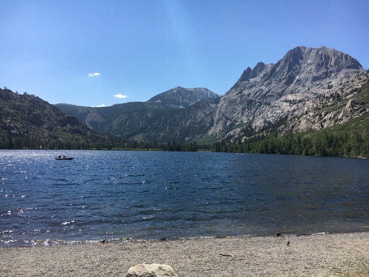 the june lake in california resting below tall, rocky mountains