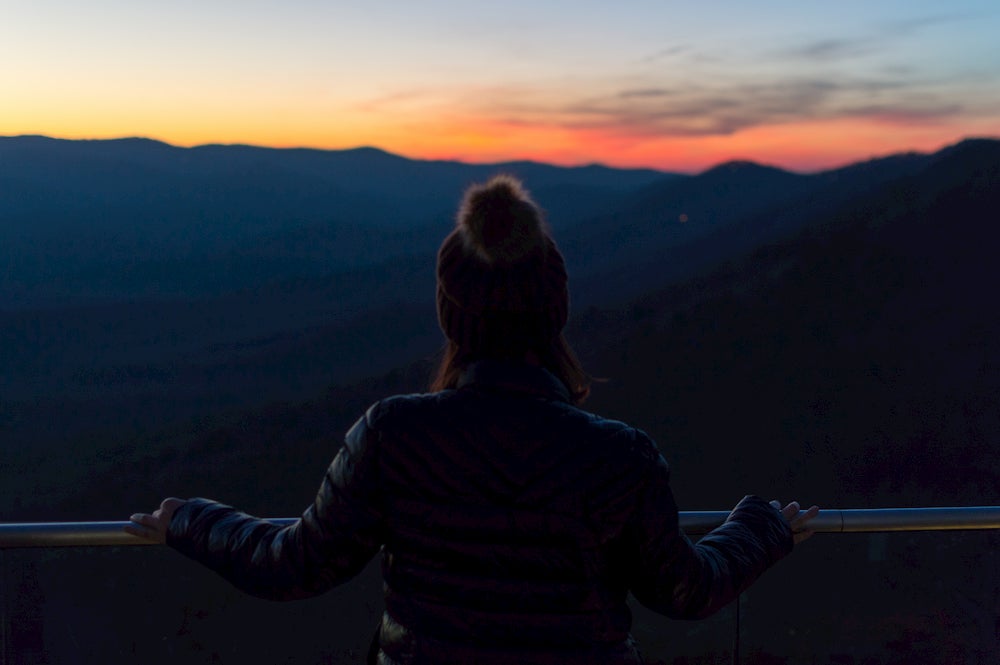 faint silhouette of girl in winter hat looking out at sunset in amicalola falls state park