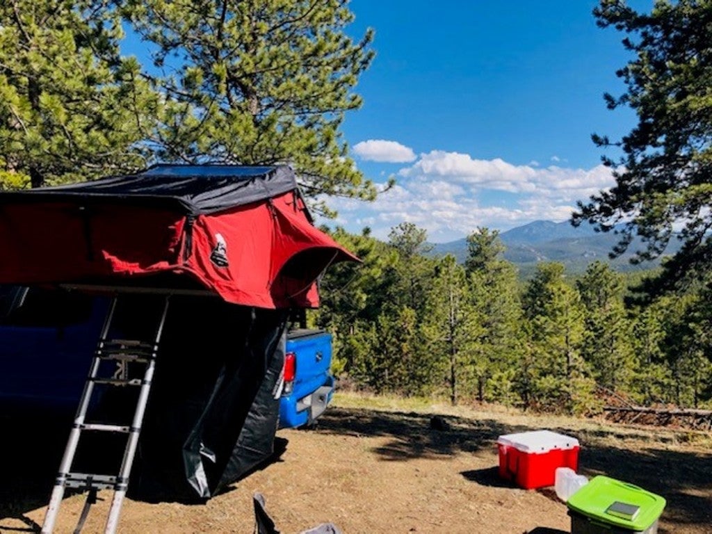 a pop up tent on a truck at a campsite in colorado