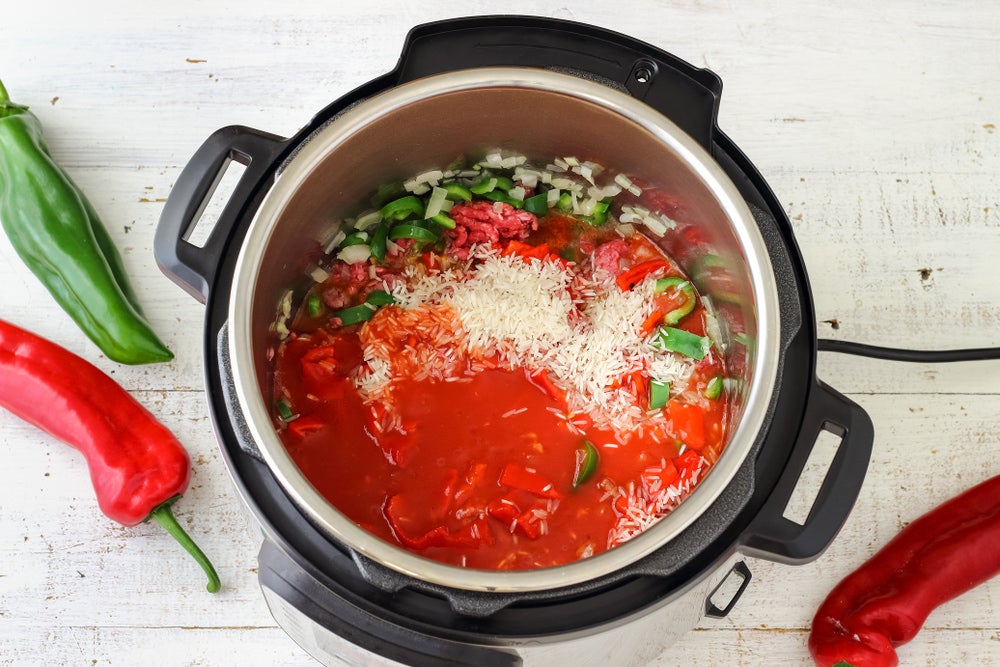 Instant pot with tomatoes, rice, and peppers inside