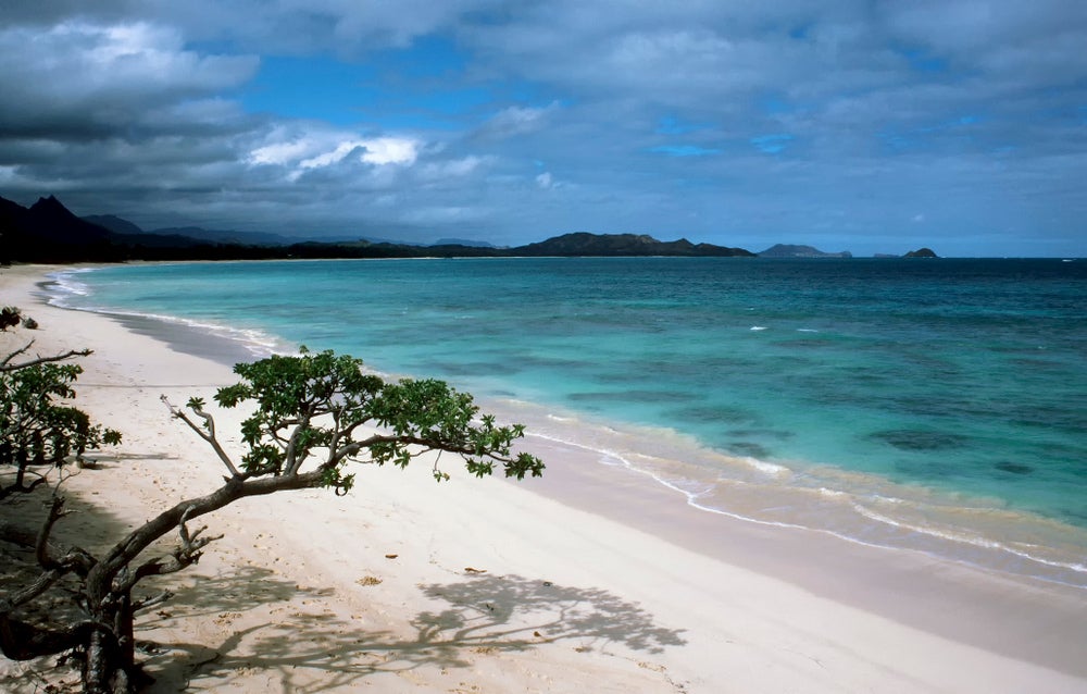 Oahu beach with white sand and bright blue water.