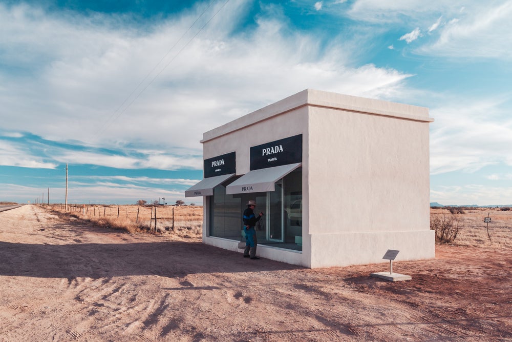 Cowboy at Prada Marfa installation in the desert.