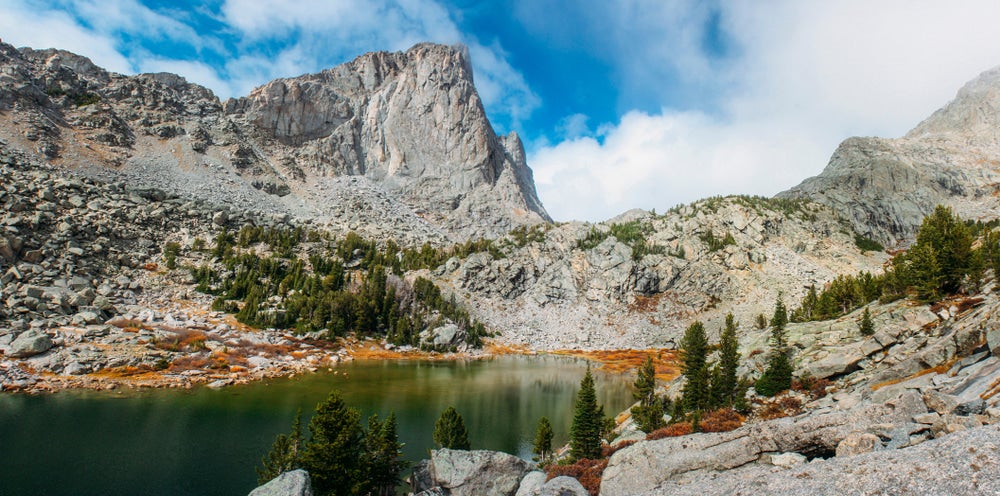 towering grey rock peaks shrouded in fog