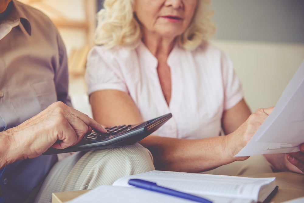 an elderly couple organizing their finances and buying a campground