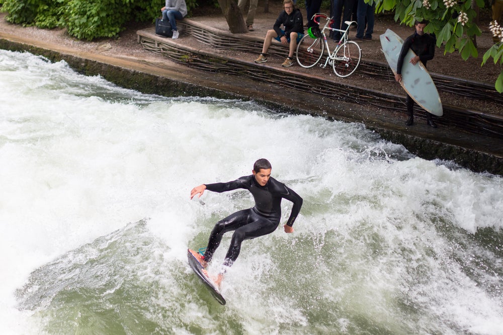 Surfing ripping a large river wave.