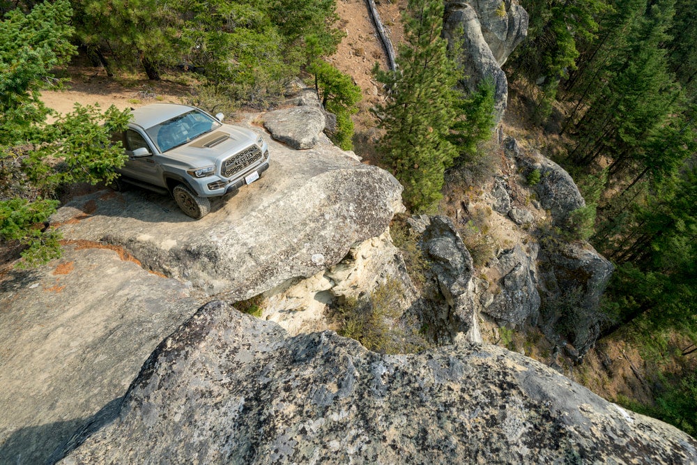 Toyota tacoma at the edge of a cliff.