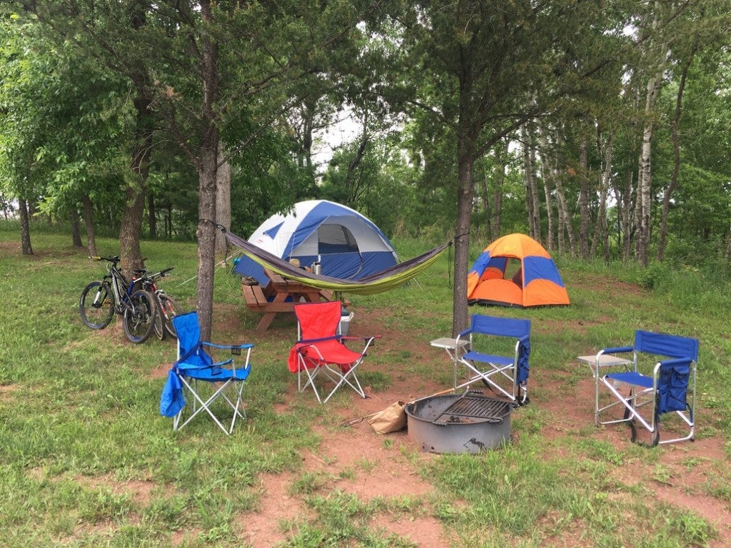 a campsite with two tents, four chairs and mountain bikes in minnesota