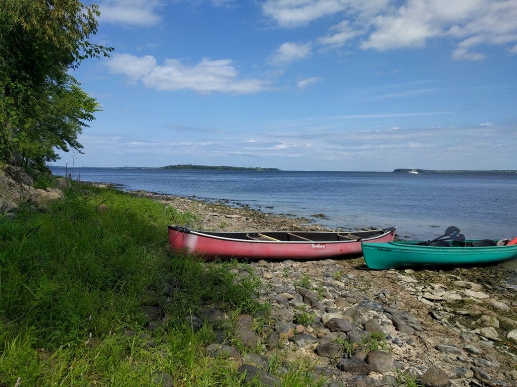 two canoes resting on the rocky shore of lake champlain