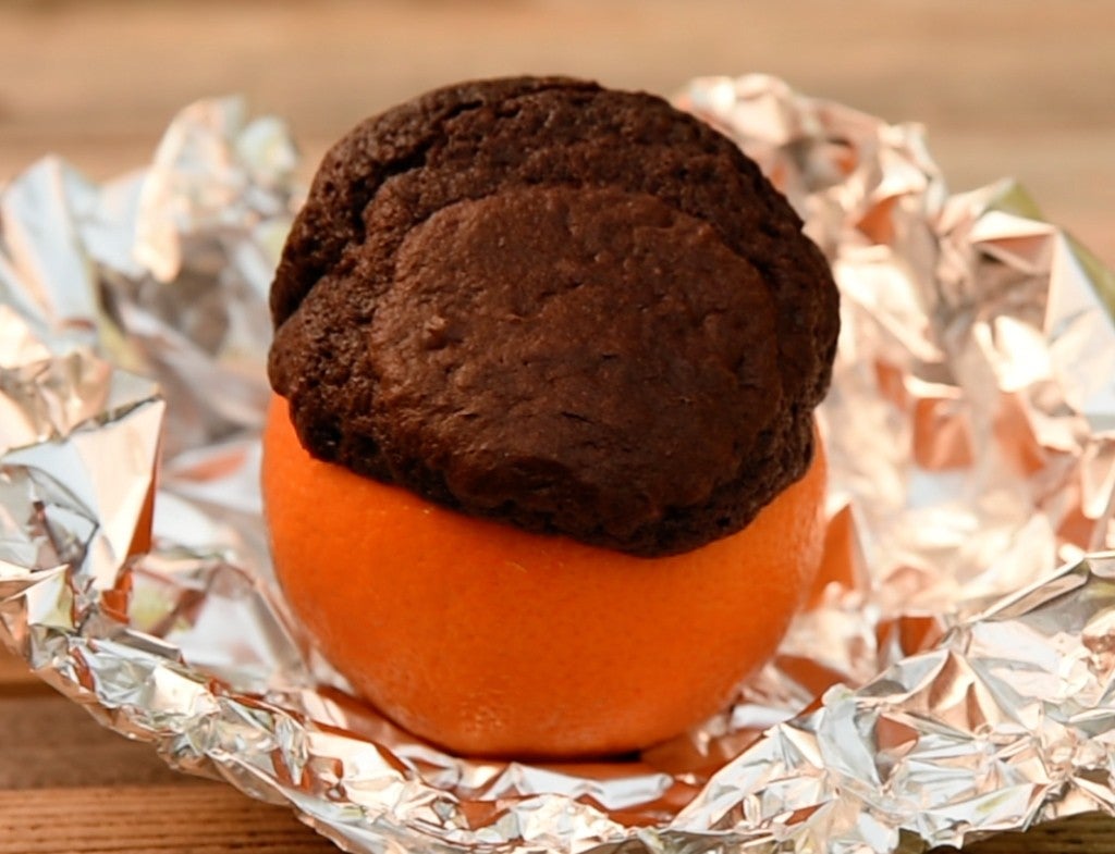 a brownie cooked in an orange in tin foil