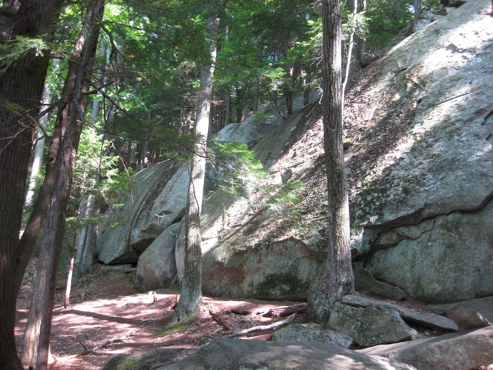 a row of tall boulders for climbing in pawtuckaway state park