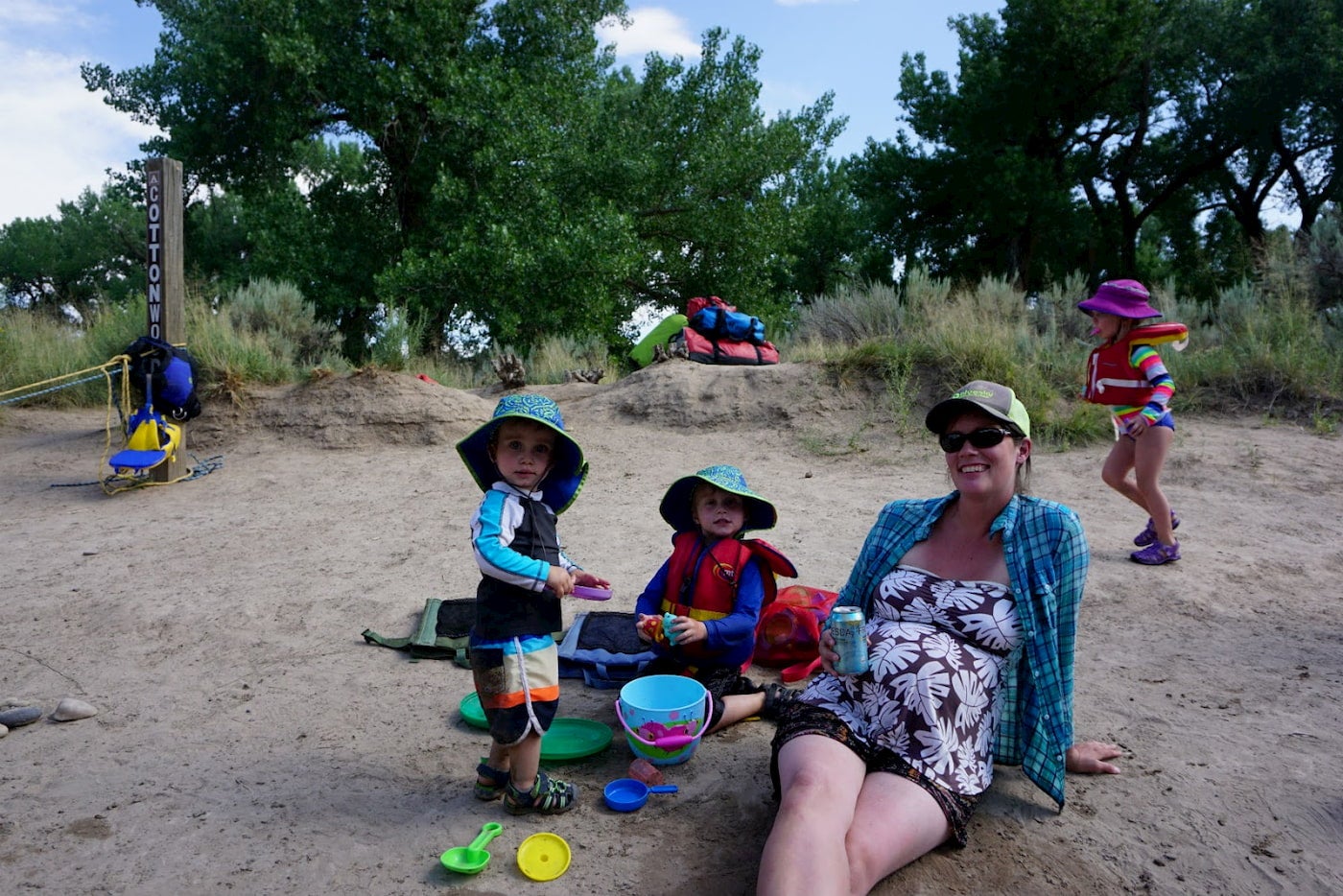 Pregnant mother on the beach with her children.