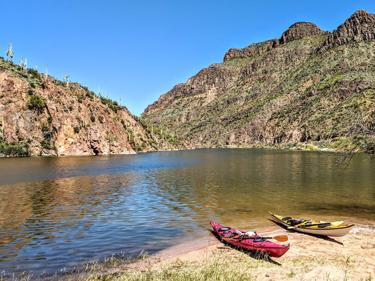 two kayaks on the shore of a lake in the superstition mountains