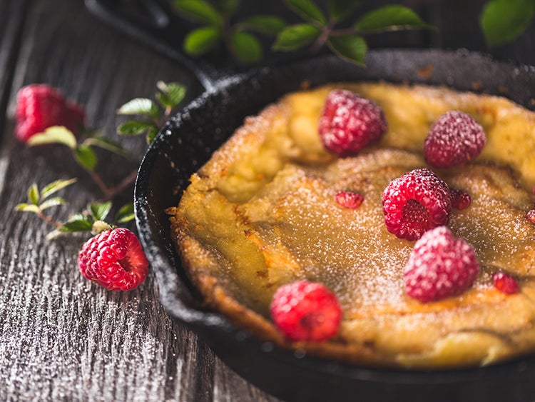 close up of raspberry dessert in a cast iron skillet 