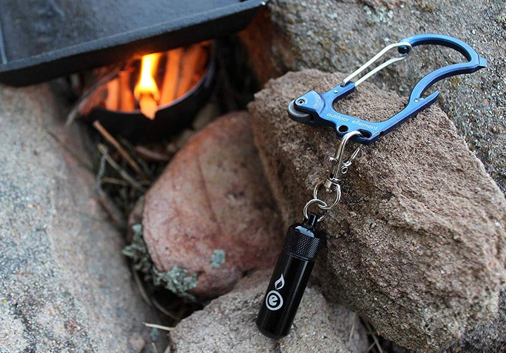 Outdoor Element firebiner resting on a rock.