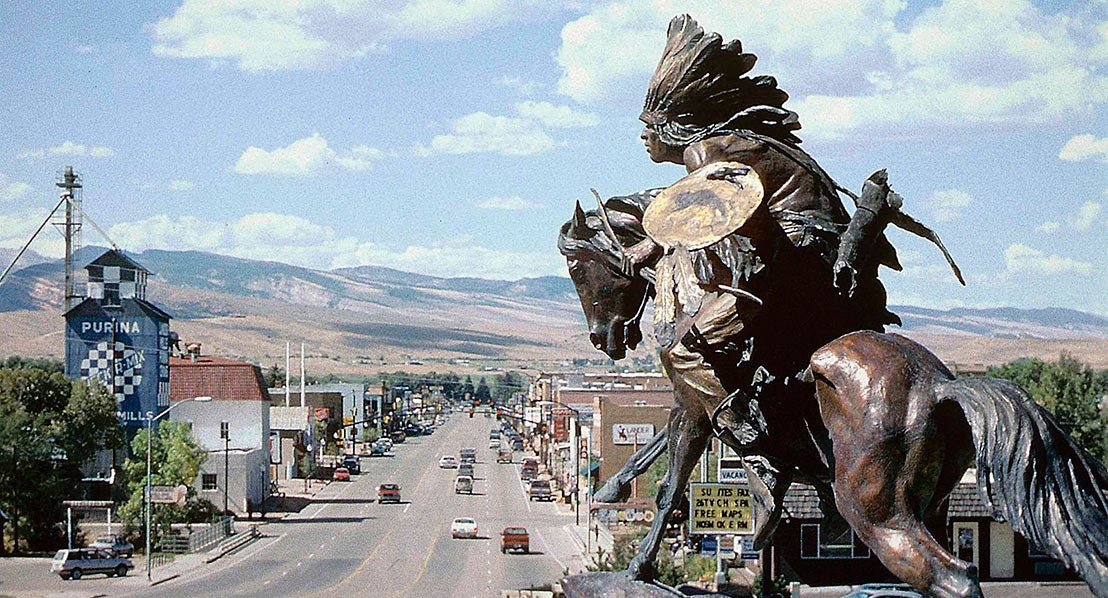 a downtown view of lander wyoming with a statue of a native american