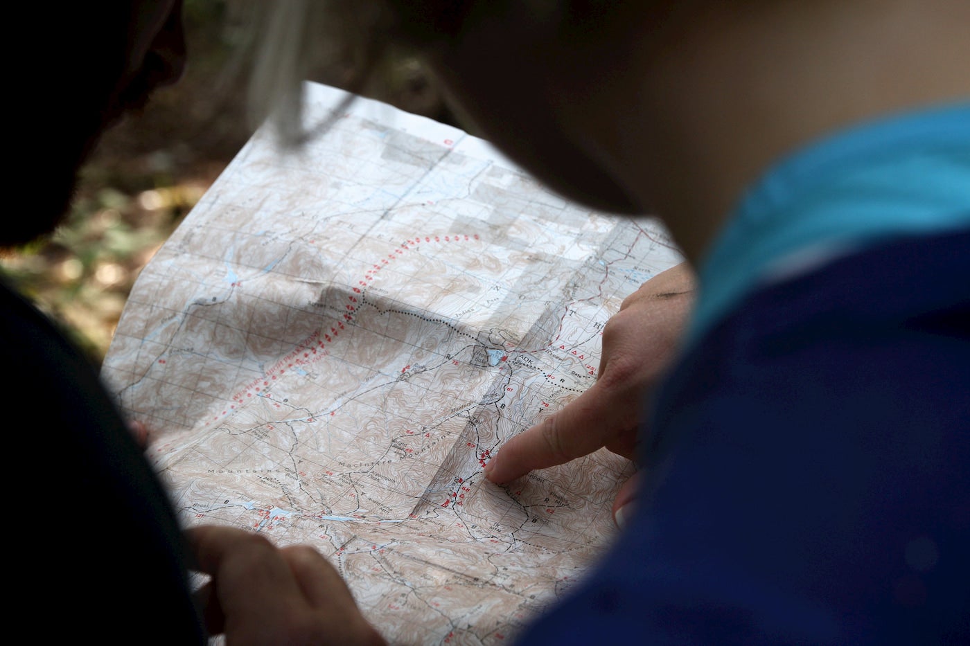 People reading a topographic map.