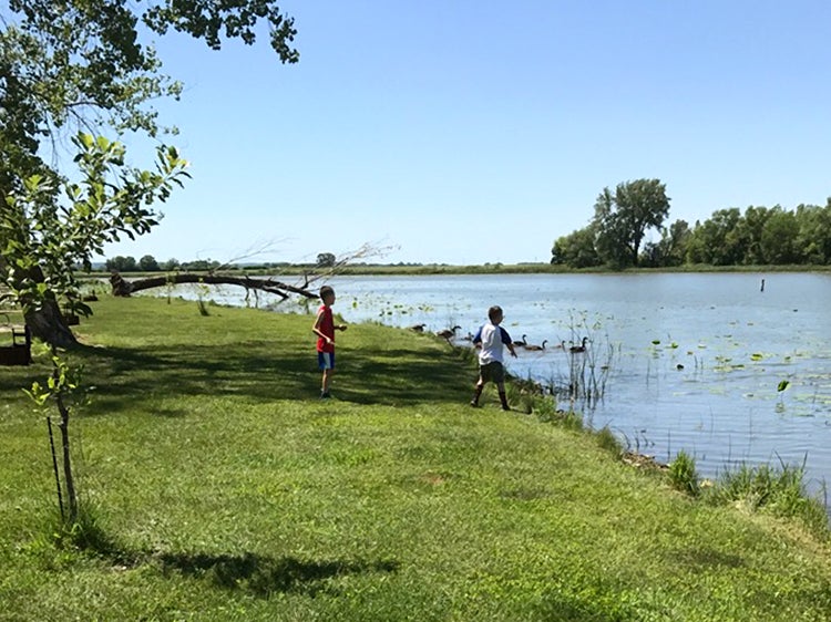 two kids playing near water at lewis and clark state park iowa
