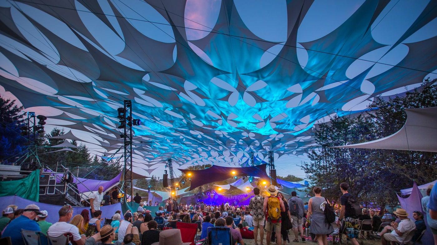 Blue lights and tent with people at concert