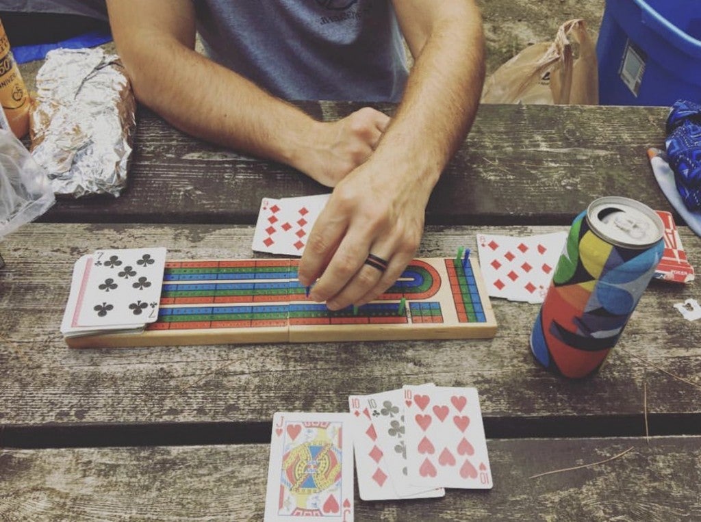 a group of people playing a board game at a campground