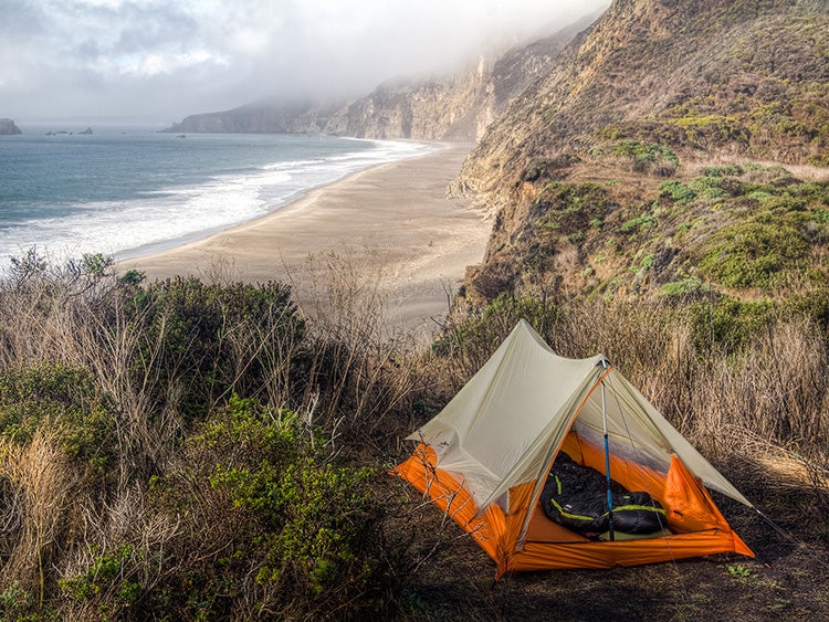 minimalist camping tent on beach