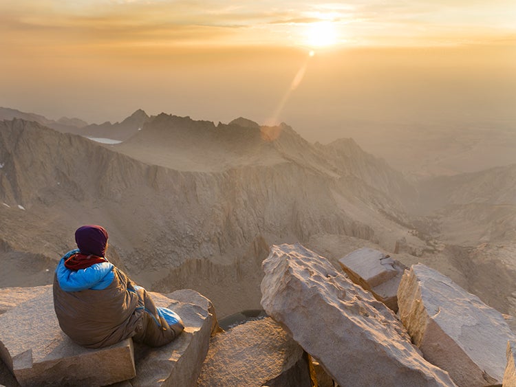 hiker on mount whitney summit at sunrise