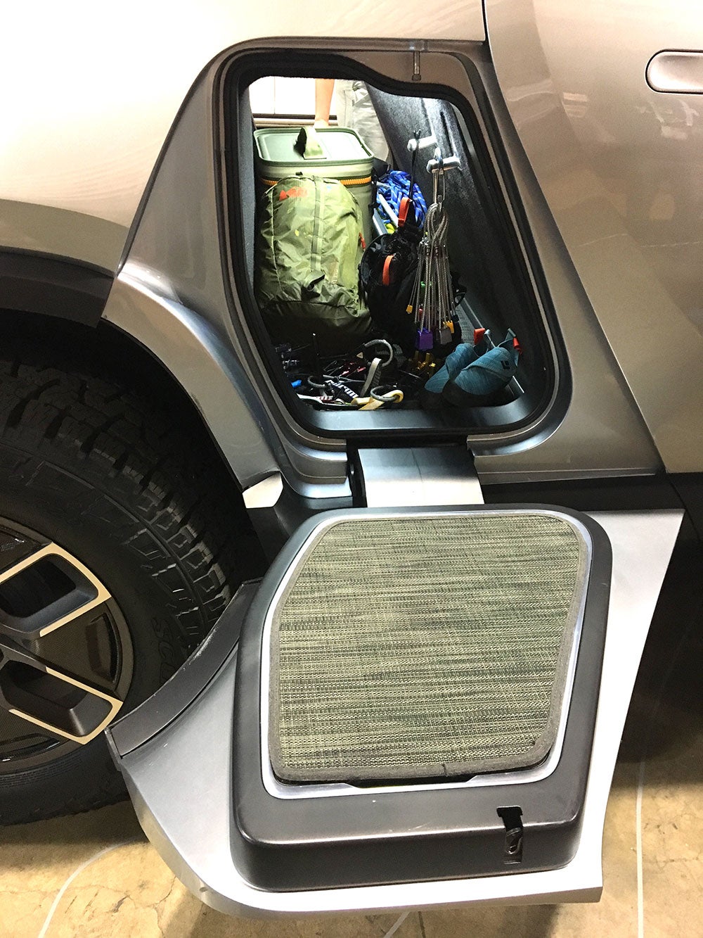 Gear storage tunnel beneath backseats of the Rivian electric truck 