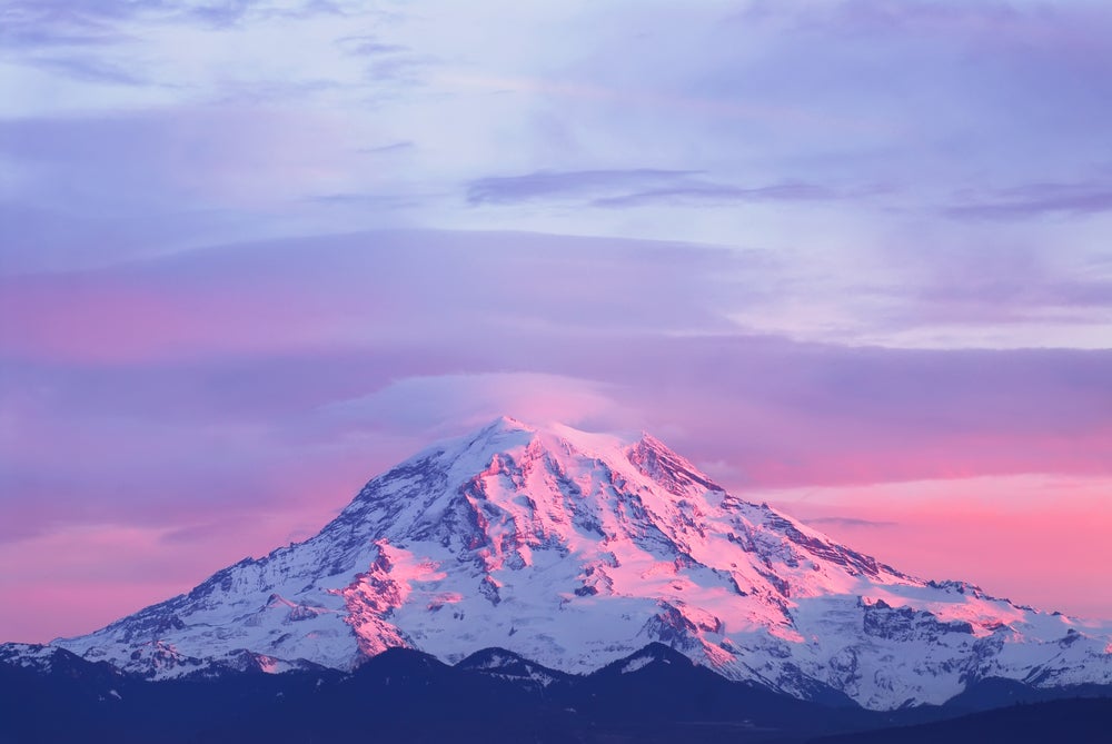 mount rainier with a pink sunset on it