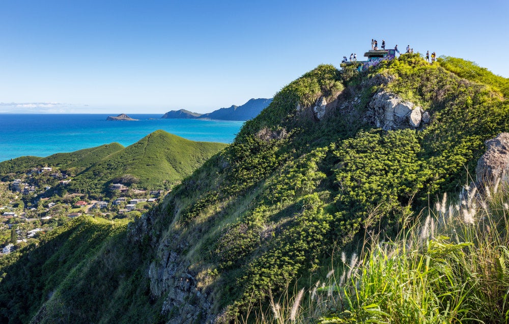 a distant view of hikers on top of pillbox hill after a hike in oahu