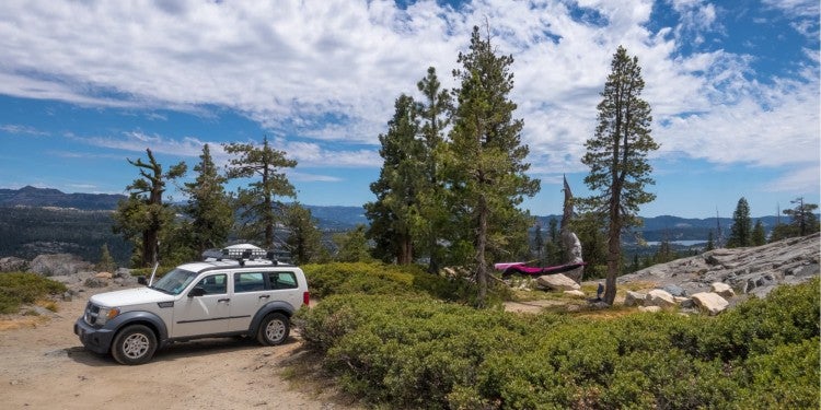 a car parked next to a hammock site in california