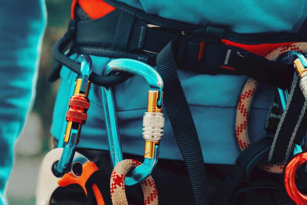 Locked carabiners on the harness of a climber.