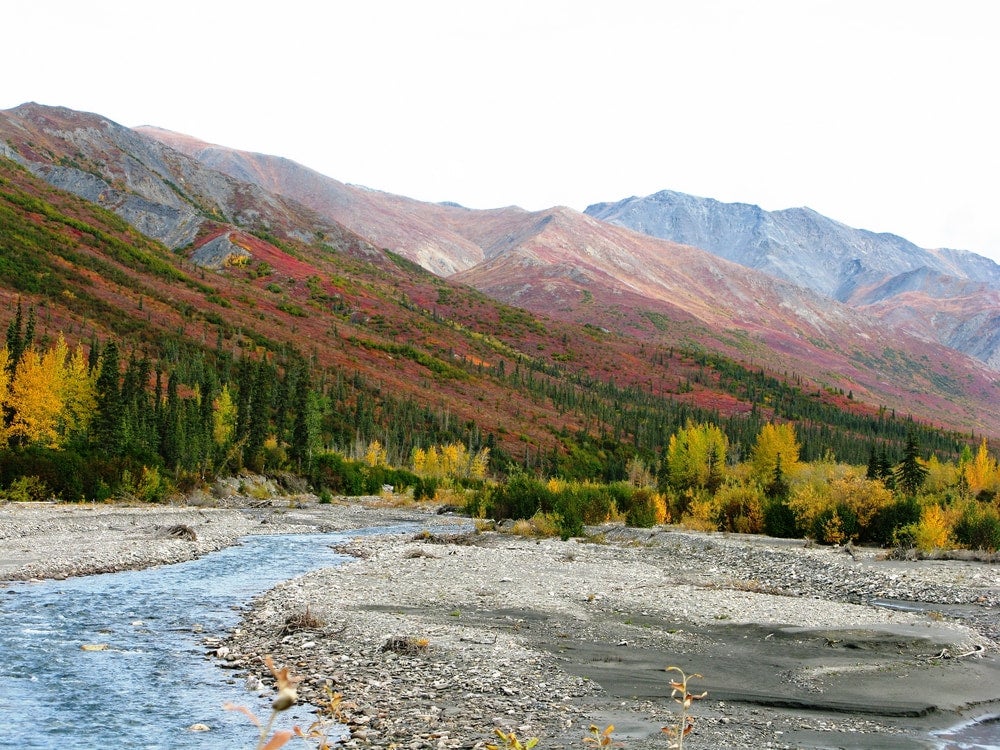 the brooks mountain range in alaska with a river running through