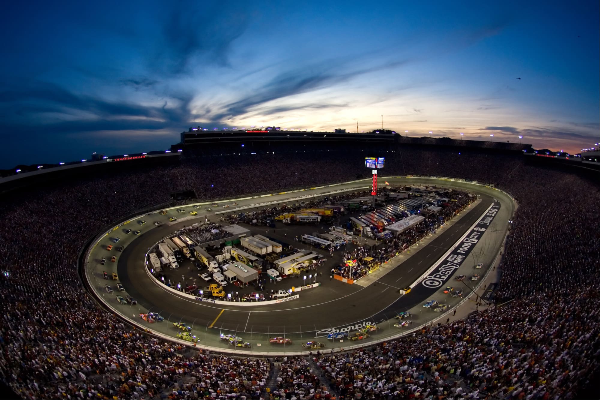 the bristol motor speedway at night during a nascar race